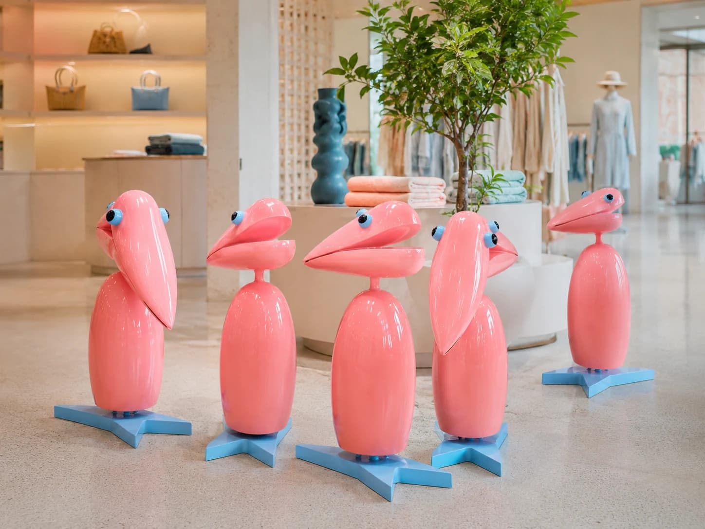 Pink sculptural branded props displayed as repeated visual elements in a commercial environment.