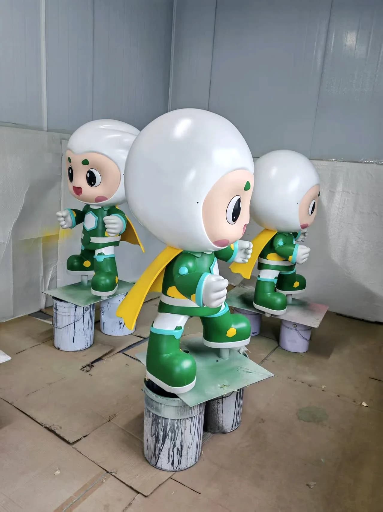 Side and three-quarter views of Treezo mascot sculptures