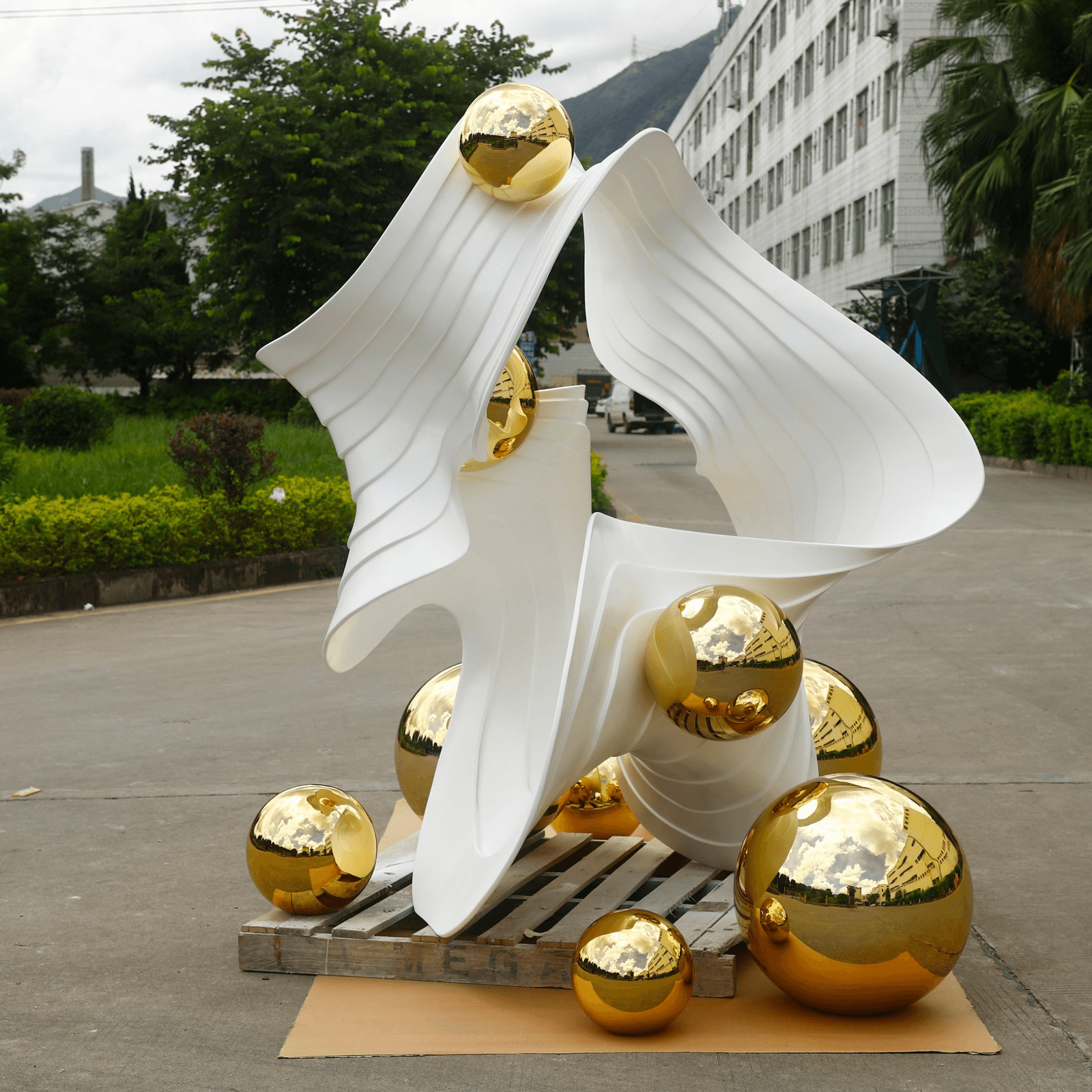 Finished complex-form sculptural display shown from a second outdoor angle