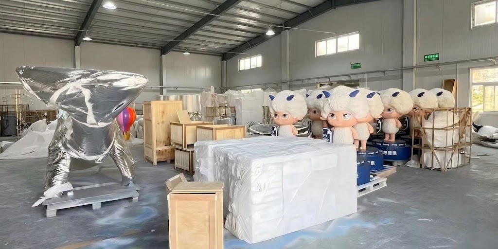 Wrapped sculptures, wooden crates and multiple finished character sculptures staged for packing in the YAVIS workshop